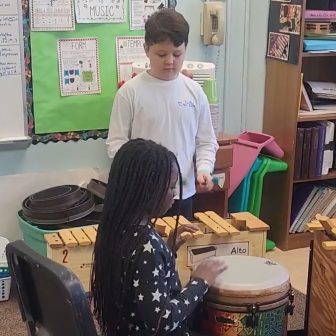 Magnet students learning to play musical instruments. 